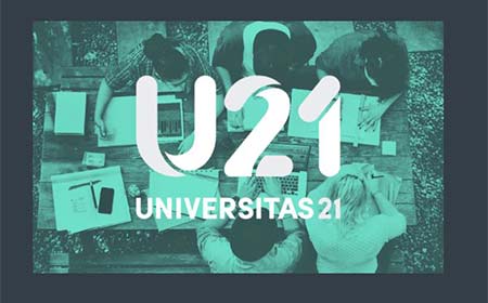 An aerial shot of people working on a table with a green overlay.